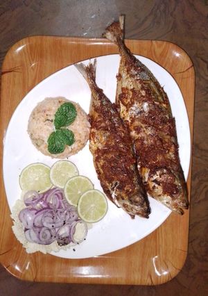 A picture of African- indo grilled fish with tomato rice and onion salad 🍅🐟.