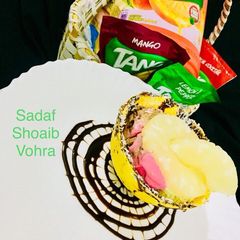 A picture of Ice cream with fruits in chocolate bowl.