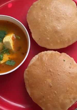 A picture of Aloo jhol and ajwain puri.