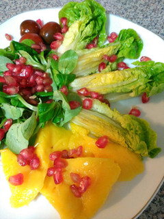 Una foto de Ensalada de cogollos, canónigos y mango con granada