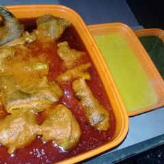 A picture of Goat meat tomato stew.