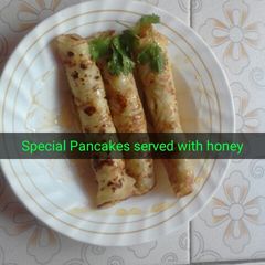 Sweet pancake served with honey A picture of Sweet pancake served with honey.