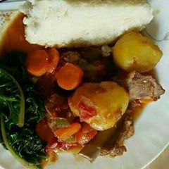 Ugali/meat and spinach A picture of Ugali/meat and spinach.