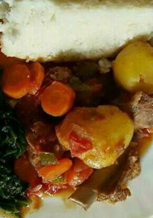 A picture of Ugali/meat and spinach.