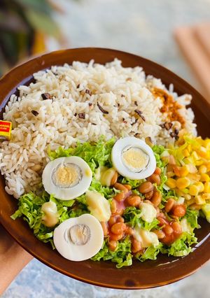 A picture of Rice and beans with salad.