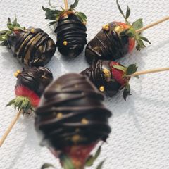 A picture of Coated dark strawberries 🍓.
