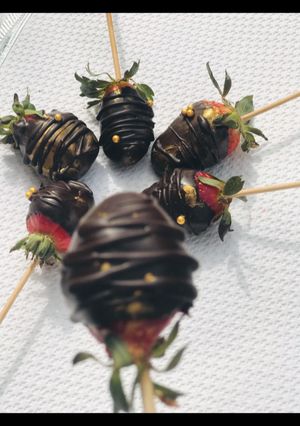 A picture of Coated dark strawberries 🍓.