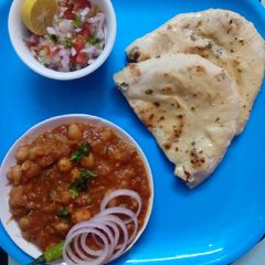 A picture of Chhole with stuffed naan.