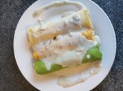 Una foto de canelones de espinaca setas