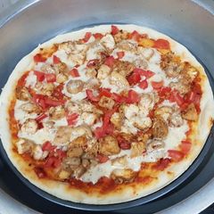 A picture of Chicken tikka pizza in lock down (karahi baking).