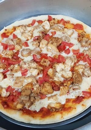 A picture of Chicken tikka pizza in lock down (karahi baking).