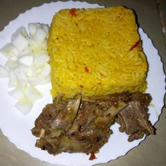 A picture of Jollof rice with steamed goat meat and cucumber #KADUNACOOKOUT.