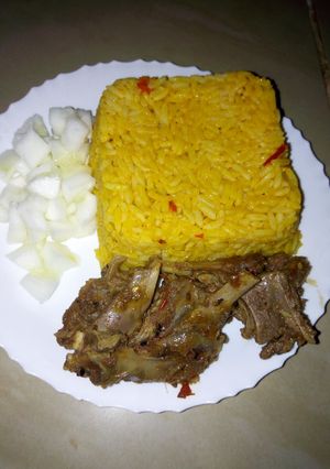 A picture of Jollof rice with steamed goat meat and cucumber #KADUNACOOKOUT.