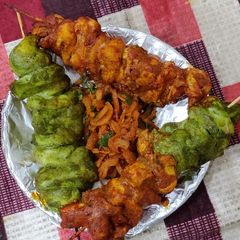 A picture of Chicken tikka kababs.
