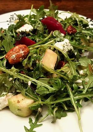 A picture of Healthy arugula,roasted beet,green apple, candied pecans salad.