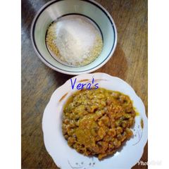 A picture of Porridge beans with garri and milk.