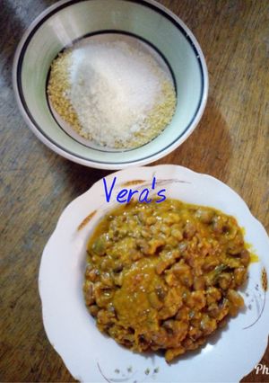 A picture of Porridge beans with garri and milk.