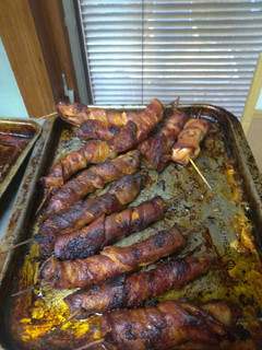 A picture of Bacon wrapped pigs wings.