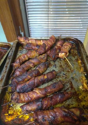 A picture of Bacon wrapped pigs wings.
