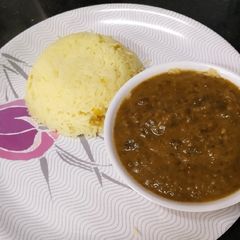 A picture of Sindhi sai bhaji with yellow rice.