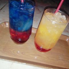 A picture of Sunrise mocktail nd Blue layered paradise.