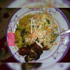A picture of Jollof rice with coleslaw.