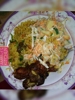 A picture of Jollof rice with coleslaw.