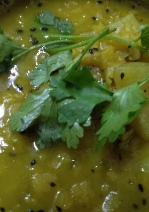A picture of Yellow peas daal with slice of radish.