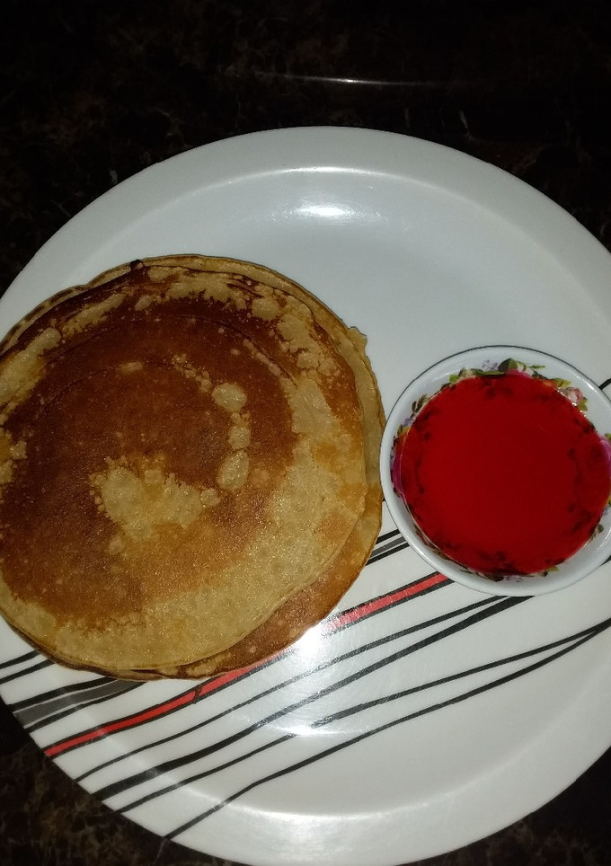A picture of Pancake with strawberry syrup.