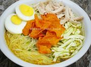 A picture of shredded chicken soup