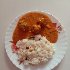 A picture of Ghee Rice with Palak Kofta Curry.