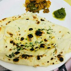 A picture of Homemade butter naan in tawa.