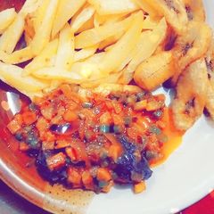 A picture of Chips nd plantain with carrot source.