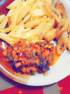 A picture of Chips nd plantain with carrot source.