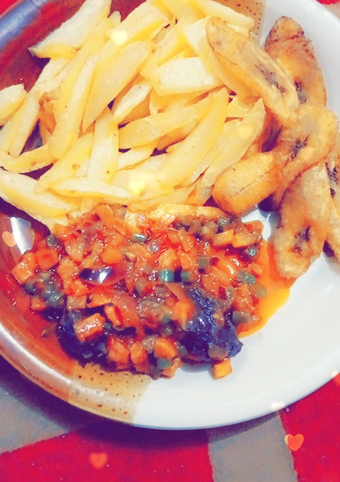 A picture of Chips nd plantain with carrot source.