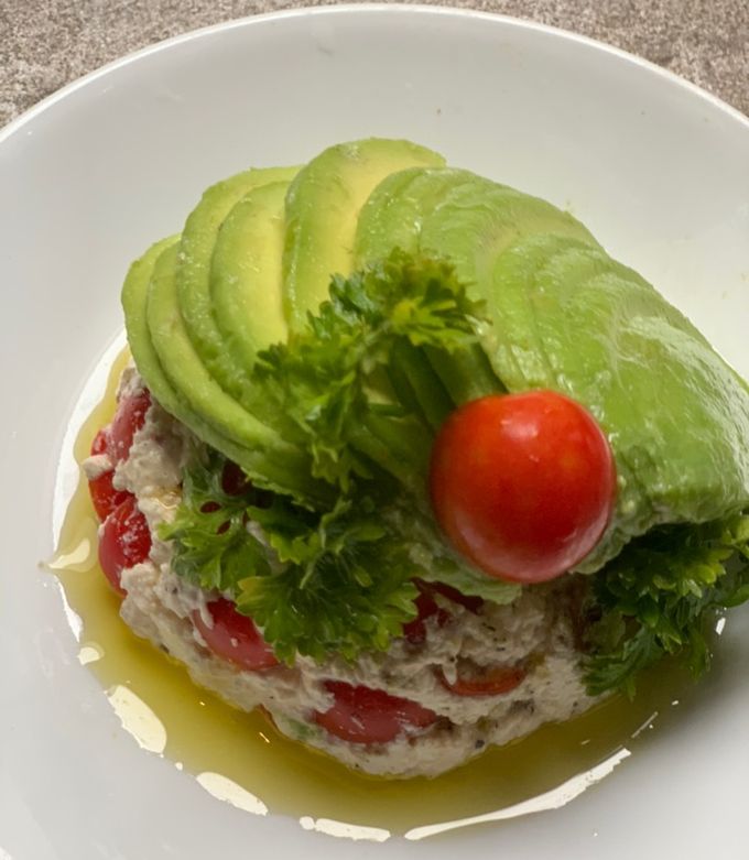 A picture of Cheese & tomatoes in avocado blanket.