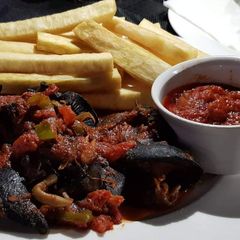 Fried yam with peppered snail A picture of Fried yam with peppered snail.