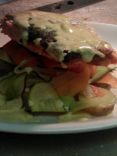 A picture of grilled salmon with ribbons of medterainian vegtables with new potatoes and lemon butter sauce.