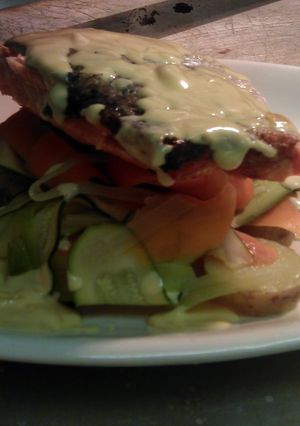 A picture of grilled salmon with ribbons of medterainian vegtables with new potatoes and lemon butter sauce.