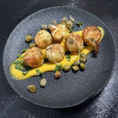 A picture of Crab balls with curry mayonnaise and capers.