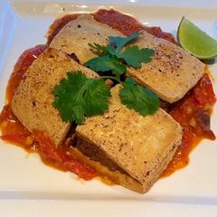 A picture of Panfried stuffed tofu with fresh tomato sauce.