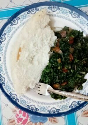A picture of Ugali with mixed greens.