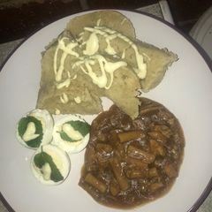 A picture of Dumpling served with pastarized chicken stew and minty eggs.