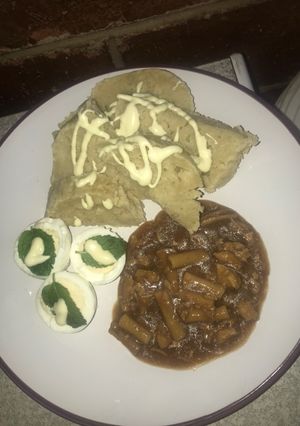 A picture of Dumpling served with pastarized chicken stew and minty eggs.
