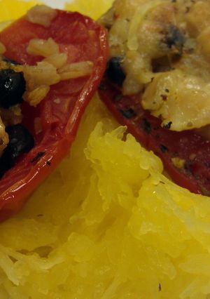 A picture of Stuffed tomatoes with brown rice.