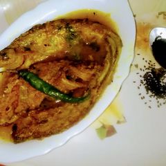 A picture of Kalo Jera Pabda Macher Jhol / Black Cumin Seeds Paste Curry.