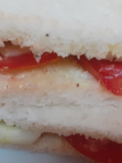 A picture of Tomato and cucumber sandwich.