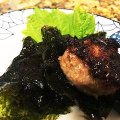 A picture of Pork meat balls with sea weed umbrella.