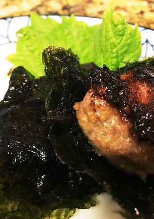 A picture of Pork meat balls with sea weed umbrella.