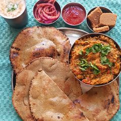 A picture of Smoky Oro with Warm Bajra Rotla – The Soul of a Gujarati Dinner.